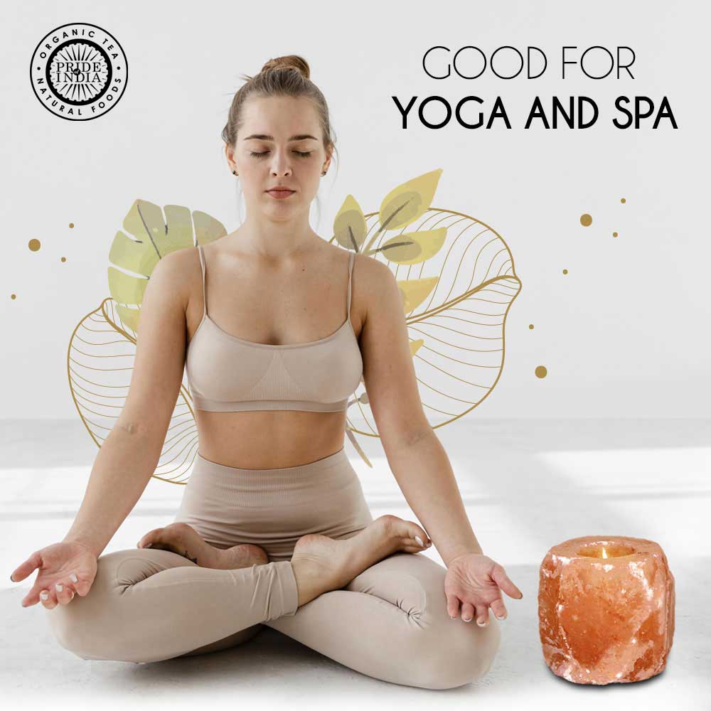 Woman in beige outfit meditating with a salt lamp and decorative elements on a light background