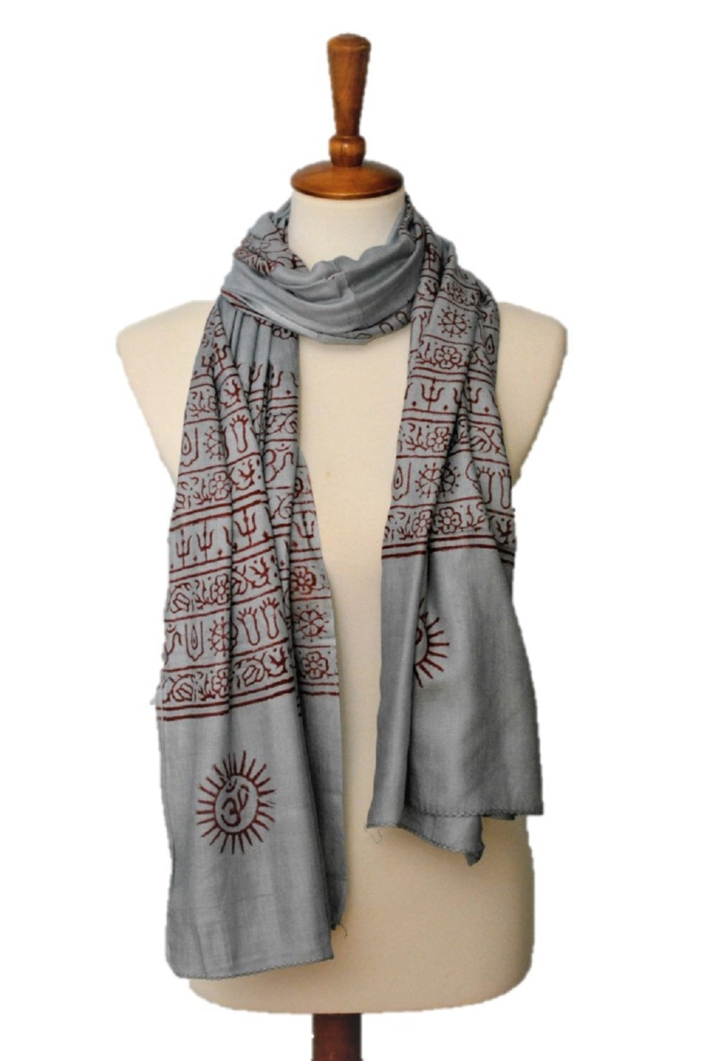 Gray scarf with red patterns on a mannequin against a white background
