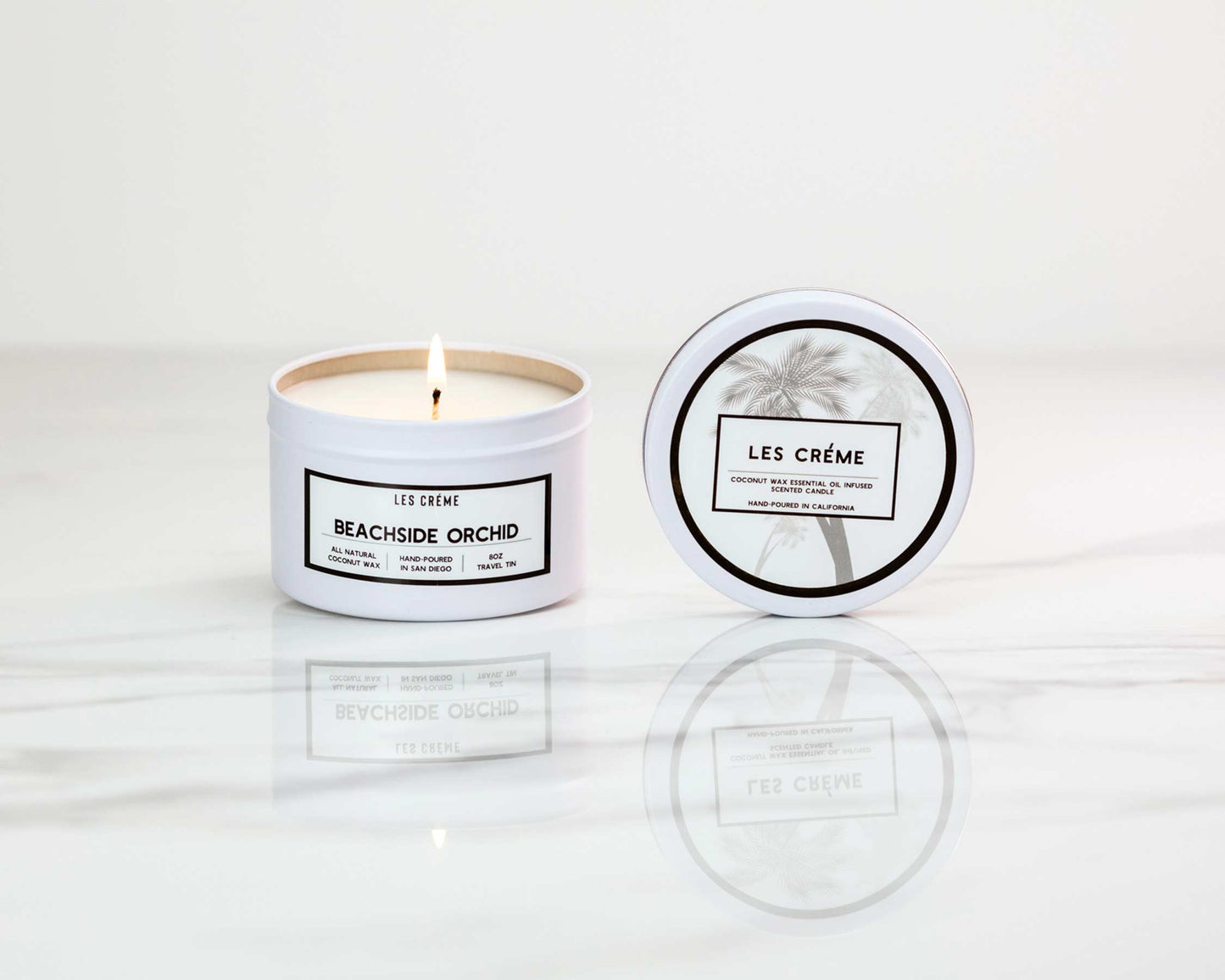 Candle with 'Les Crème' branding on a white background