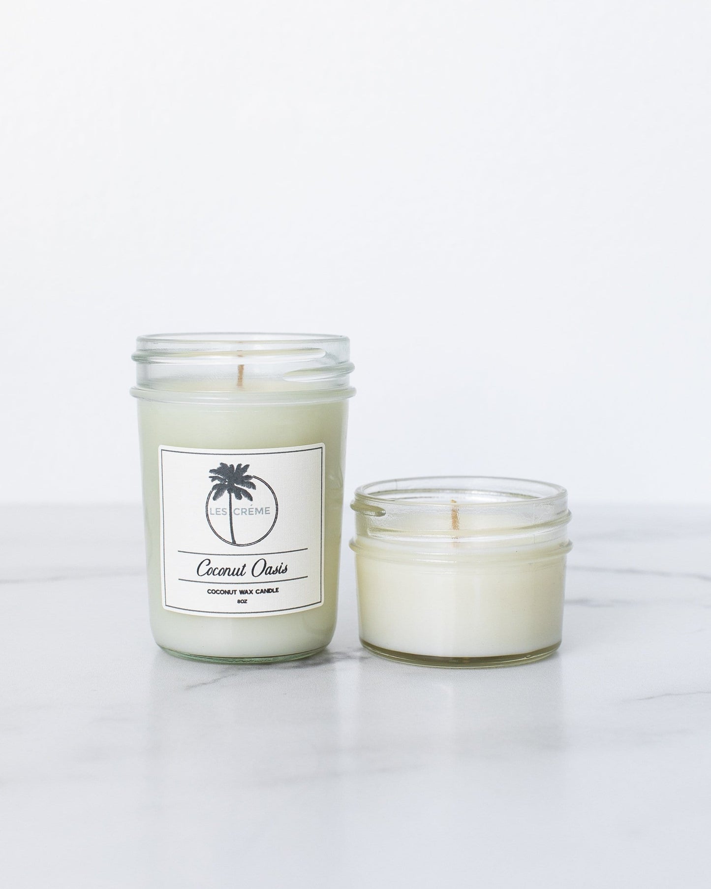 Two candles with labels on a white background
