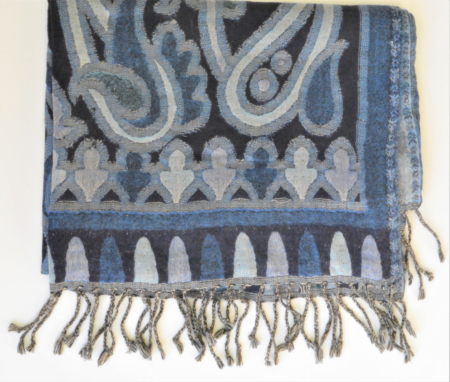 Paisley patterned scarf with fringes on a white background