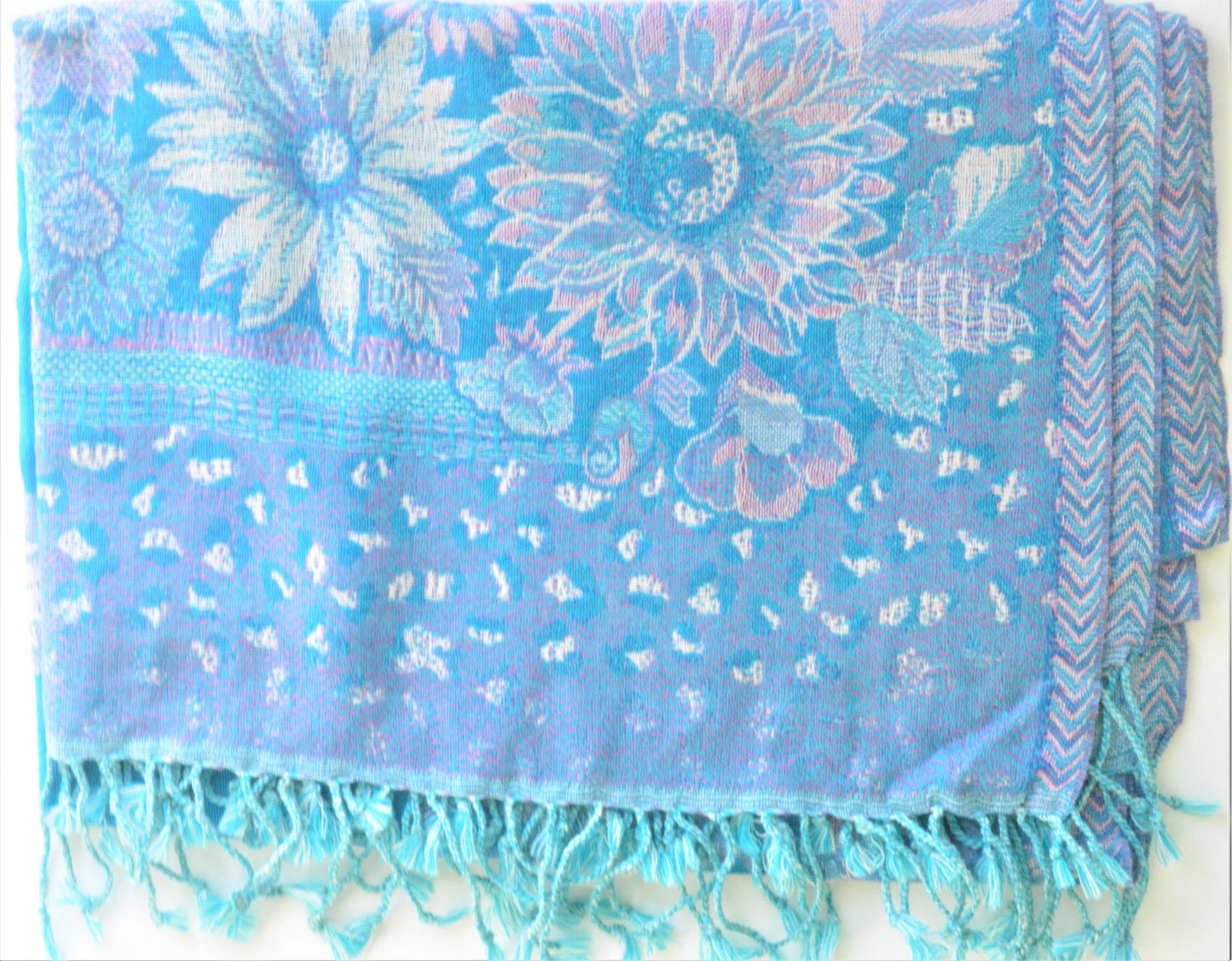 Blue floral patterned scarf with fringe on a white background