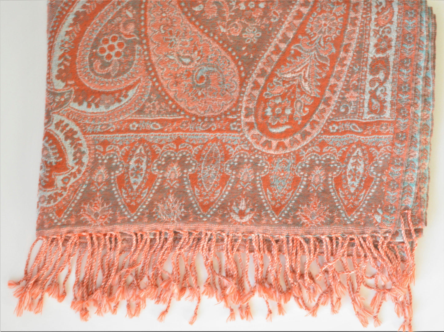 Paisley patterned scarf with fringes on a white background