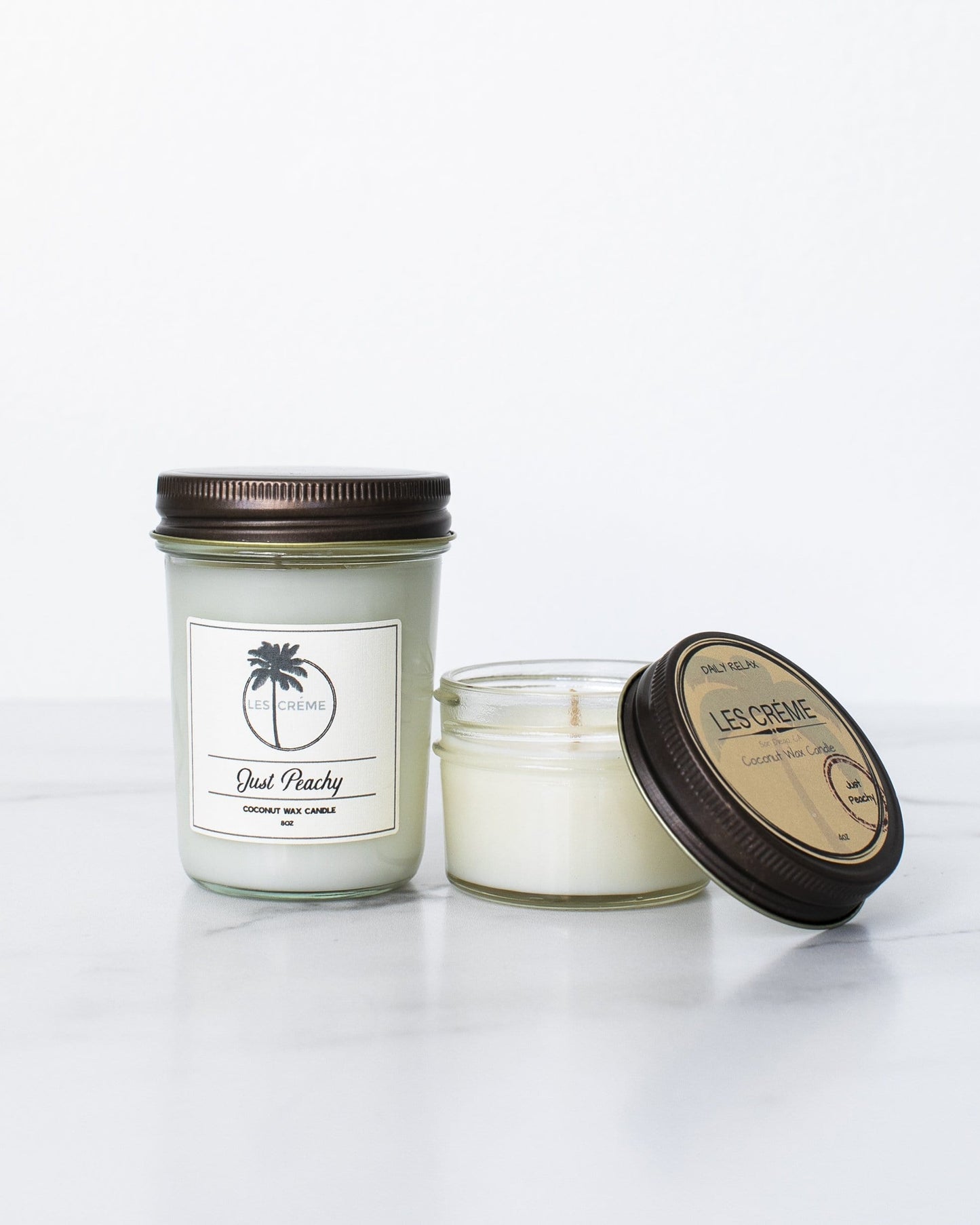 Two candles with labels on a white background