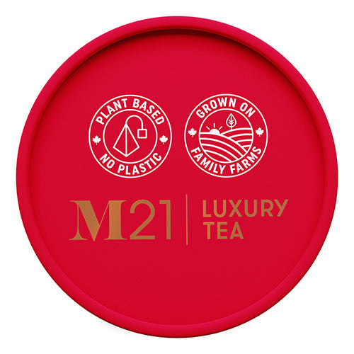 Red lid of M21 Luxury Tea packaging with branding and sustainability claims.