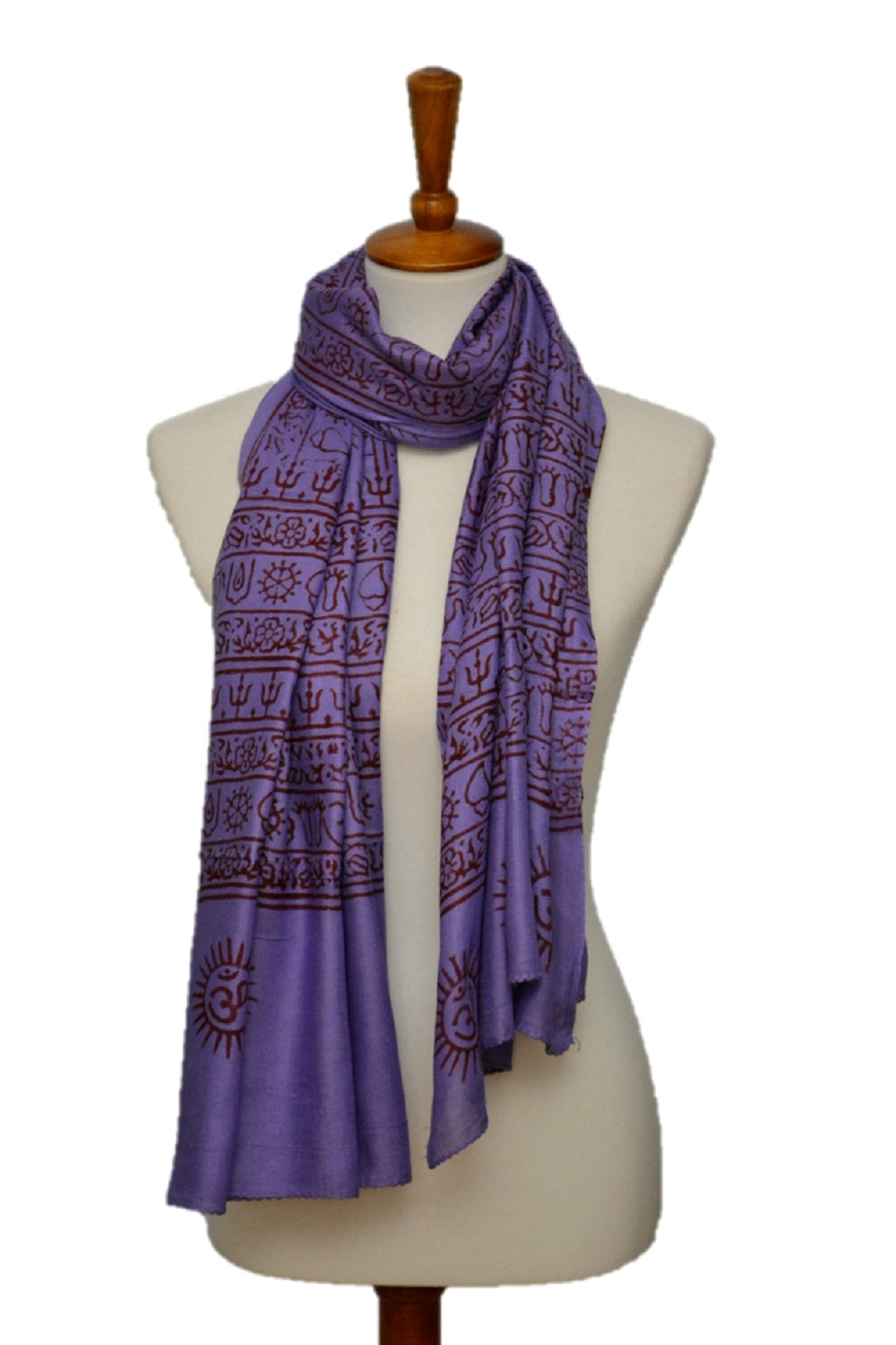 Purple patterned scarf on a mannequin against a white background