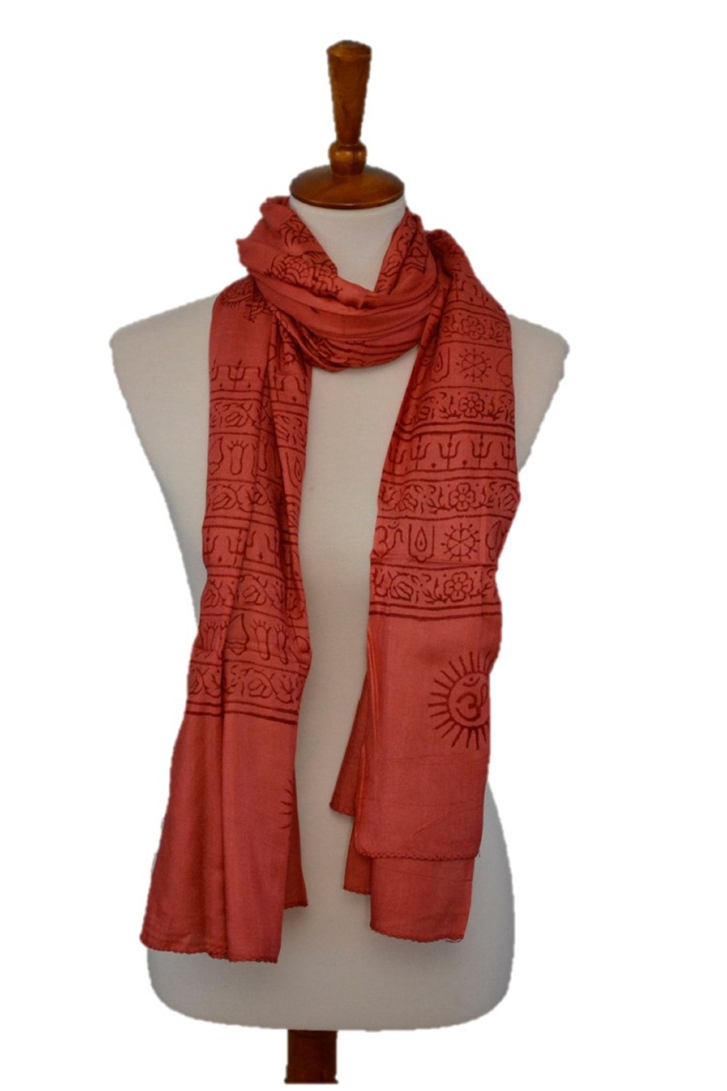 Red patterned scarf on a mannequin against a white background