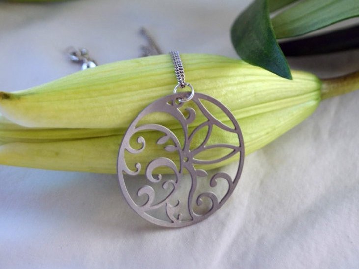 Silver necklace with a decorative pendant on a white background