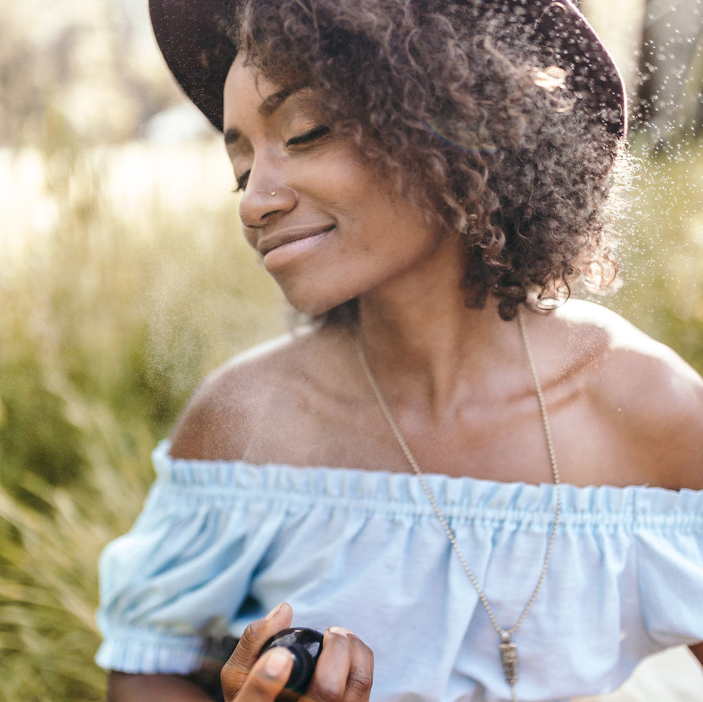 Woman wearing a wide-brimmed hat and off-shoulder top outdoors