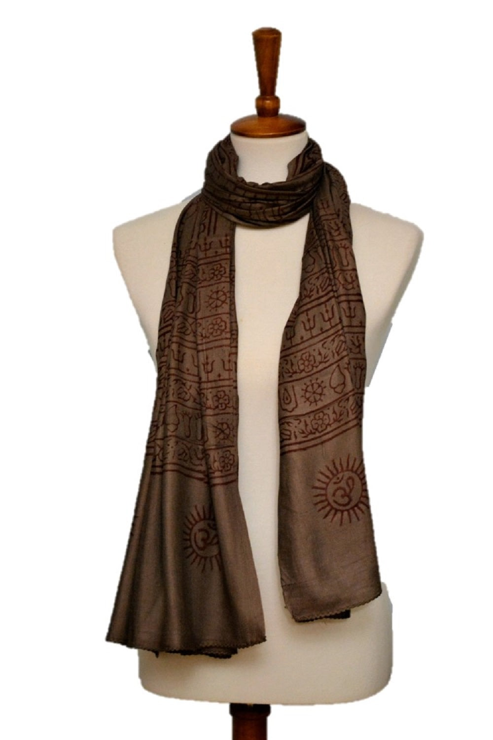 Brown patterned scarf on a mannequin against a white background