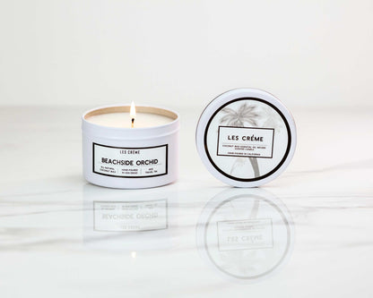 Candle with 'Les Crème' branding on a white background