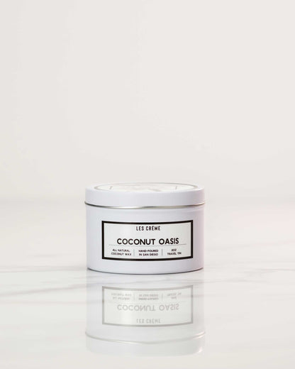 White candle labeled 'Coconut Oasis' on a white background