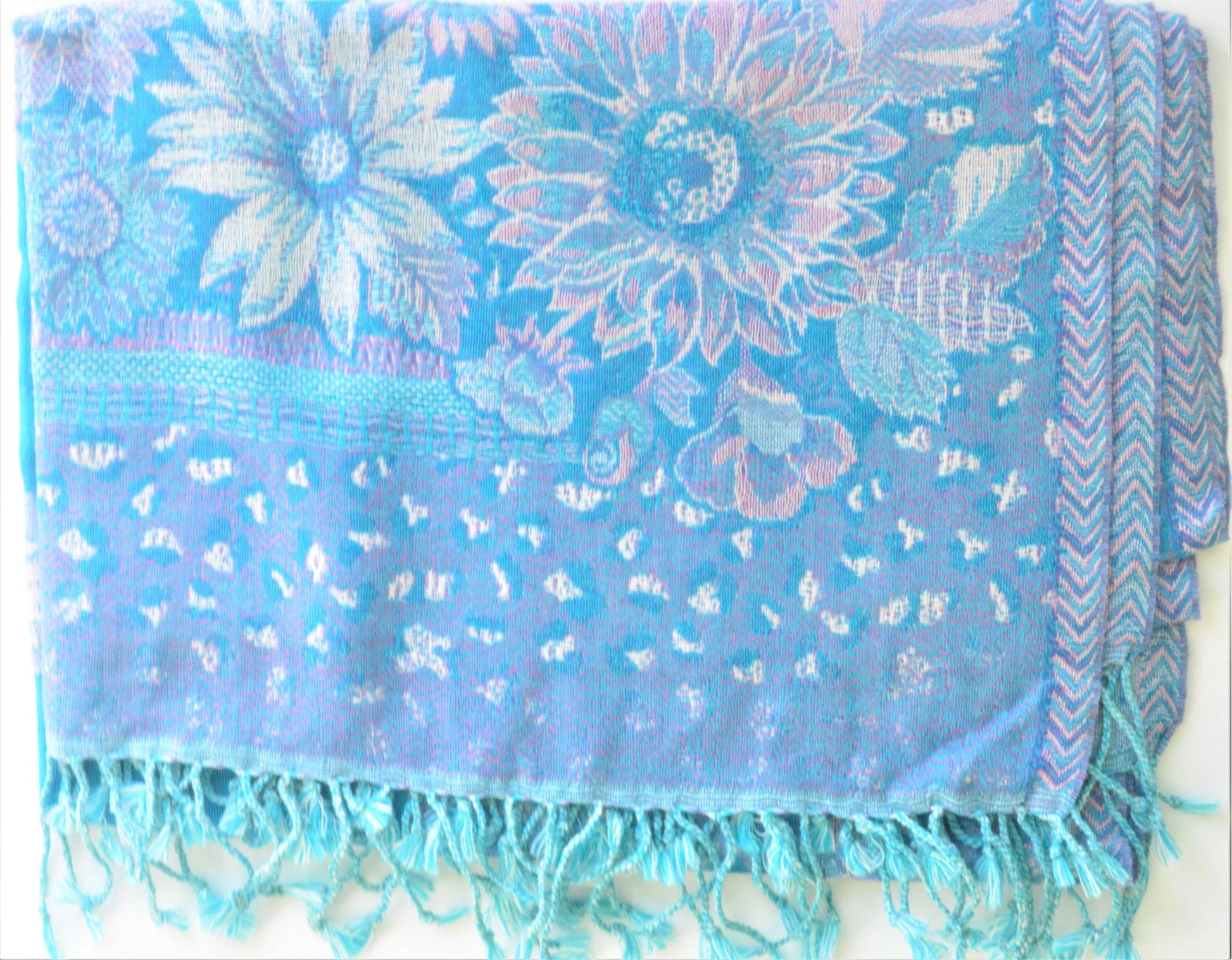Blue floral patterned scarf with fringe on a white background