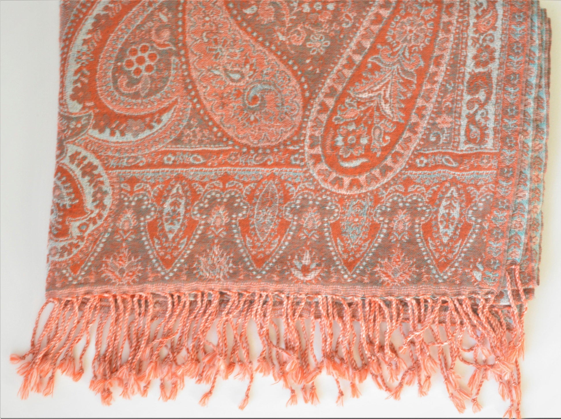 Paisley patterned scarf with fringes on a white background
