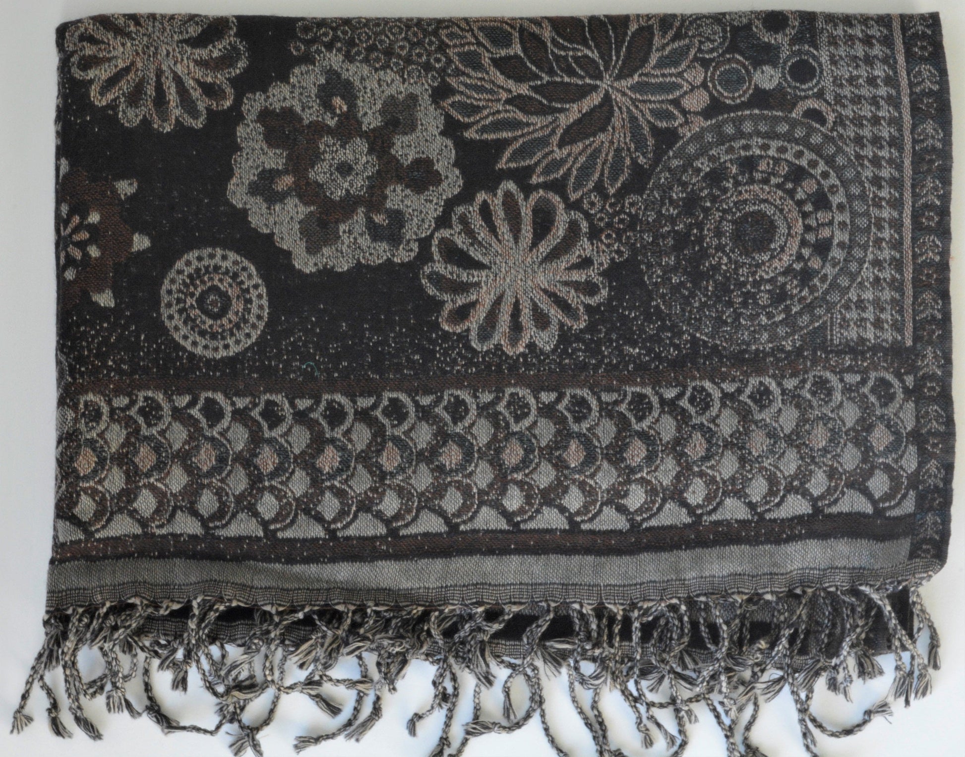 Black and gray patterned scarf with fringes on a white background