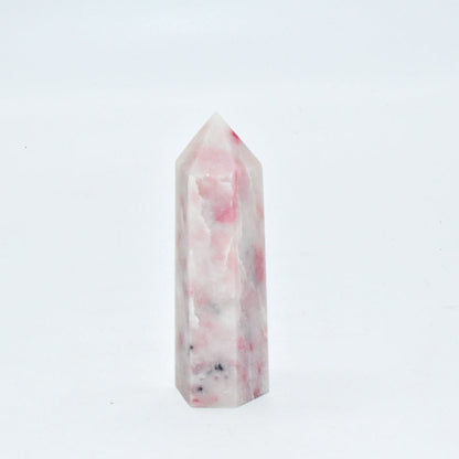 Marble-patterned crystal tower on a white background