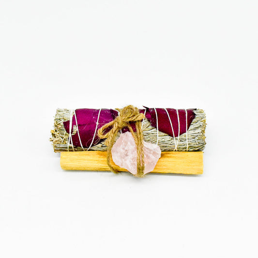Smudge stick with pink crystal on a white background