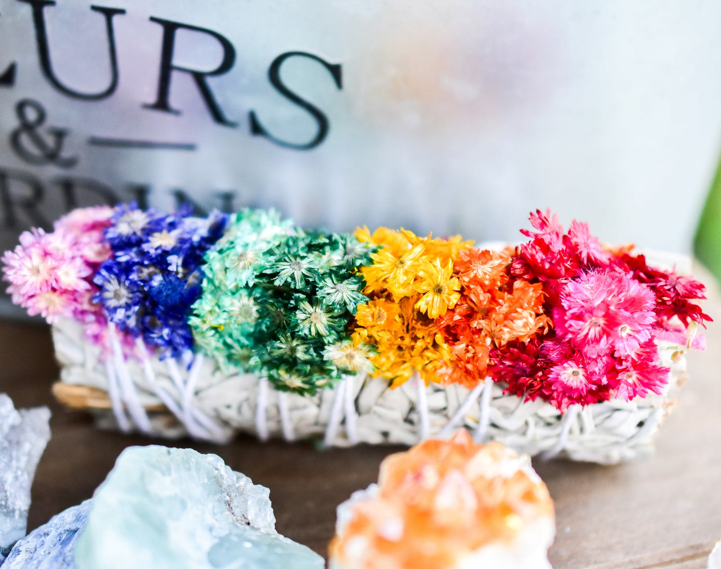 Colorful flower arrangement on a wooden surface with blurred background