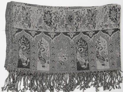Textured fabric with paisley patterns and fringes on a white background