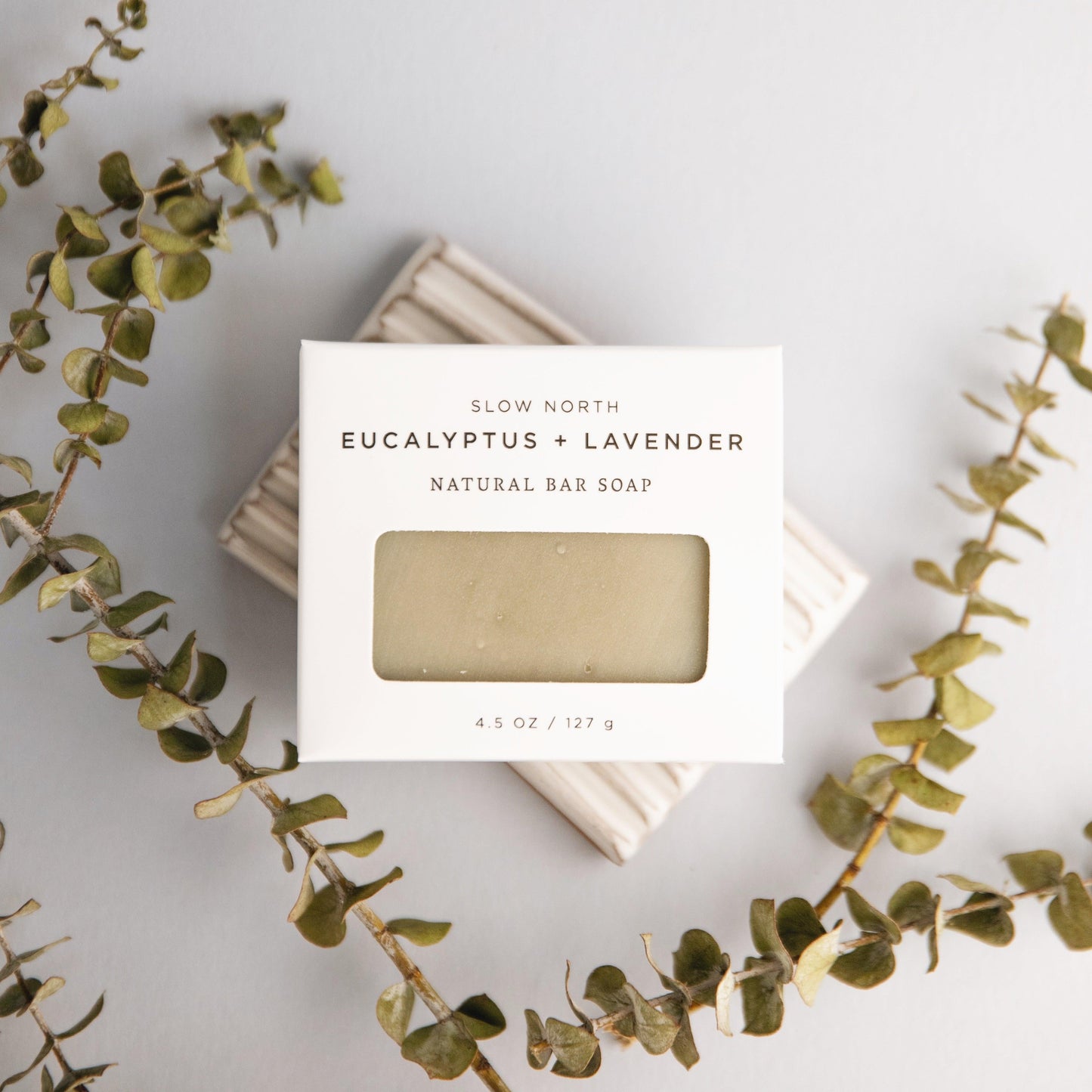 Eucalyptus and lavender natural bar soap with packaging on a light background