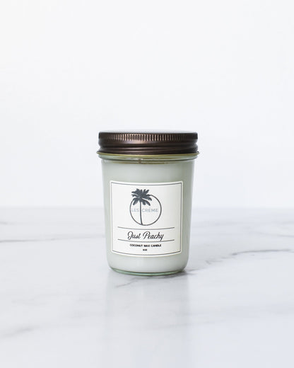 Candle in a glass jar with a brown lid on a white background
