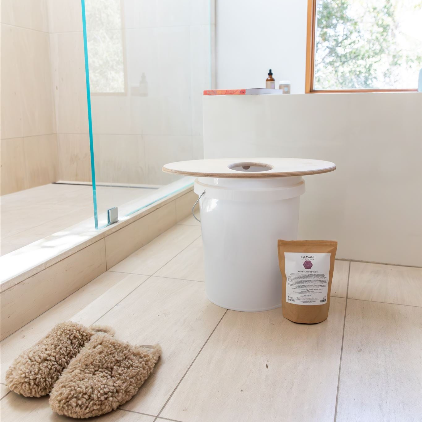 White cylindrical product on a bathroom floor with slippers and a package nearby.