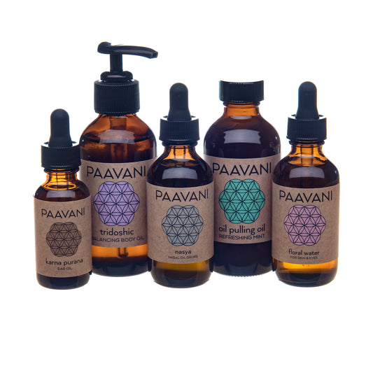 Set of PAAVANI oil bottles with different shapes on labels against a white background