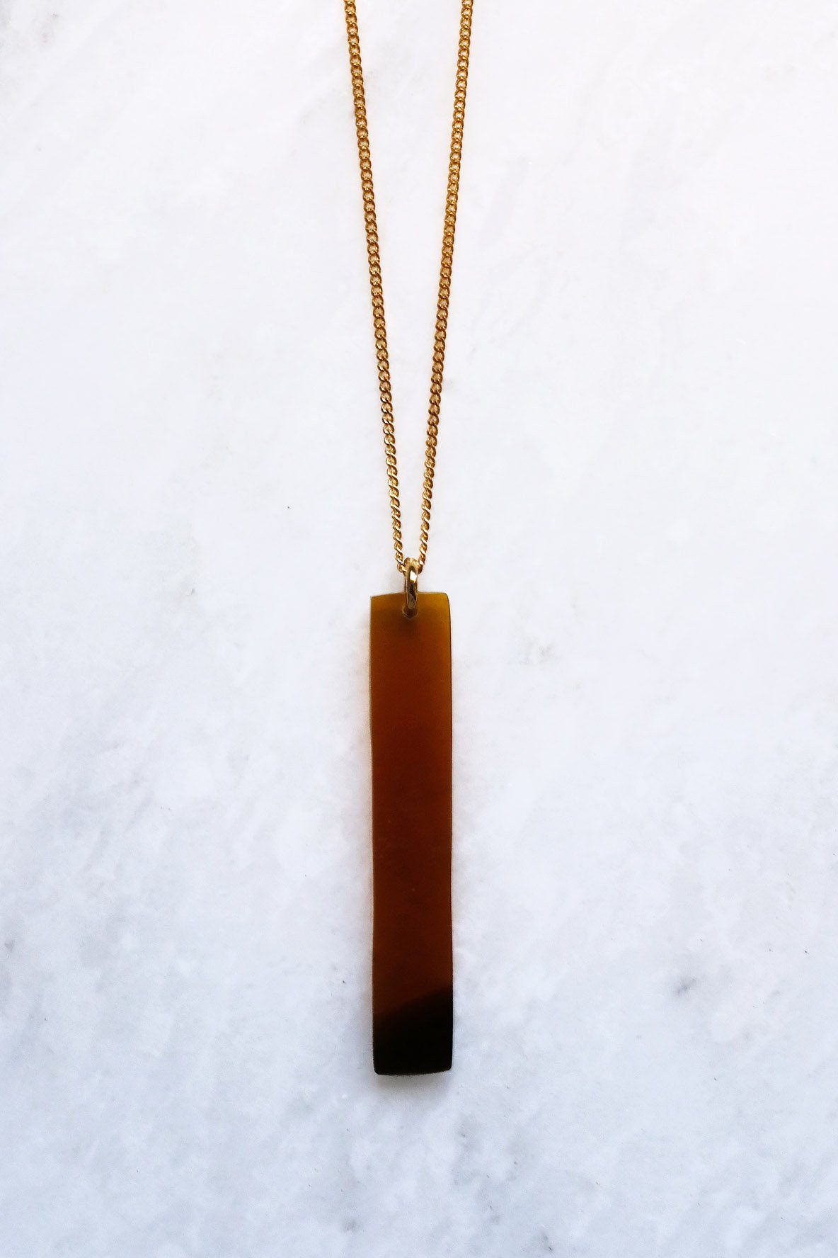Necklace with a rectangular pendant on a white background