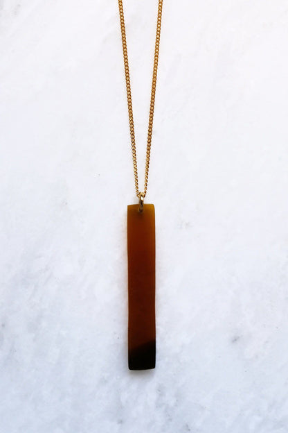 Necklace with a rectangular pendant on a white background