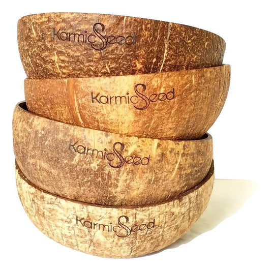 Set of four coconut bowls with 'Karmic Seed' branding on a white background