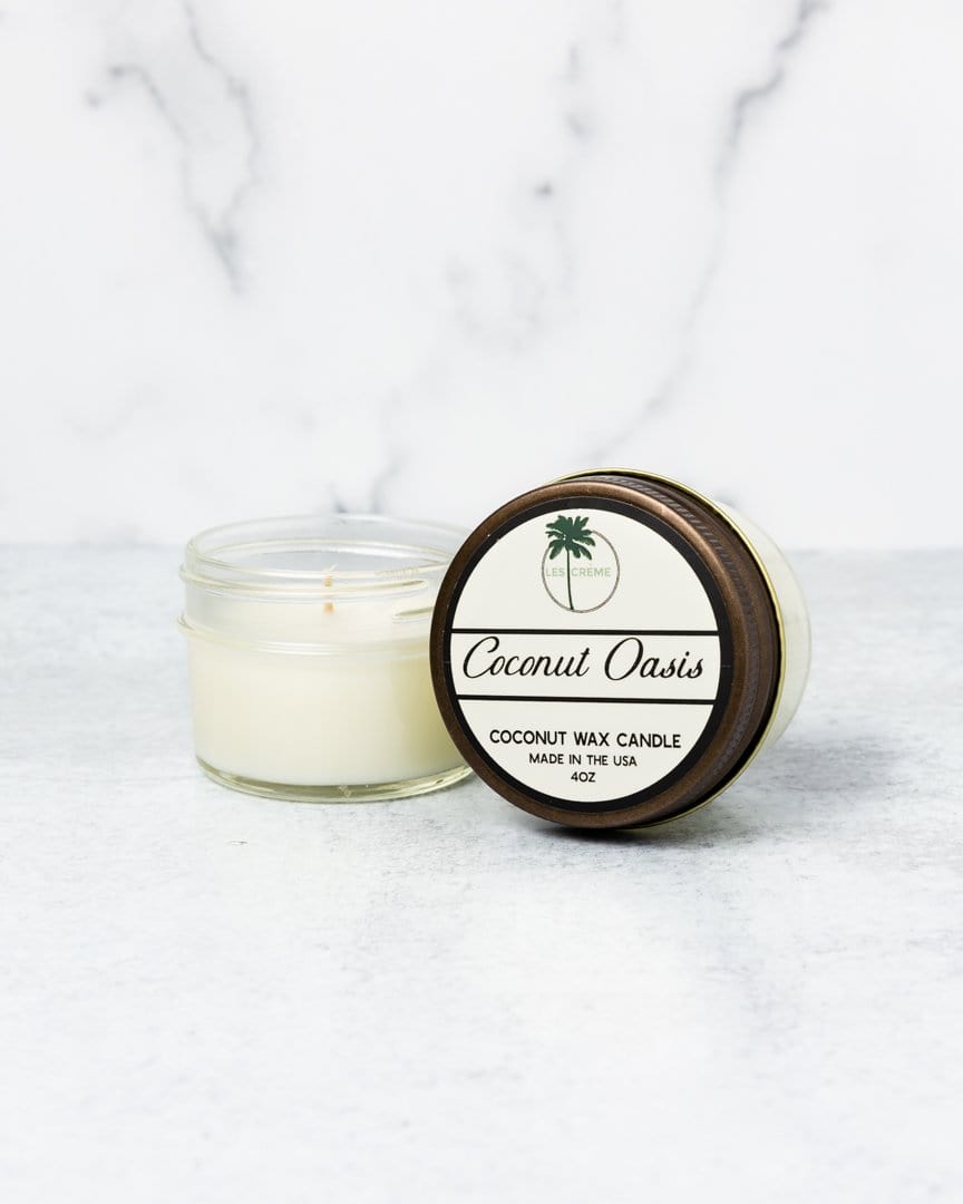 Coconut wax candle labeled 'Coconut Oasis' on a white marble background