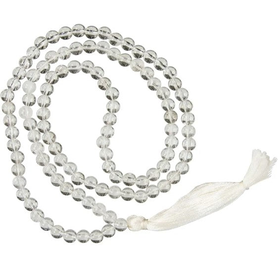 Meditation necklace with clear beads and a white tassel on a white background