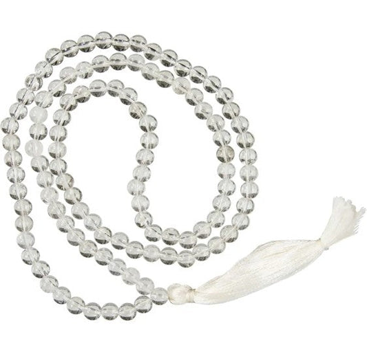 Meditation necklace with clear beads and a white tassel on a white background