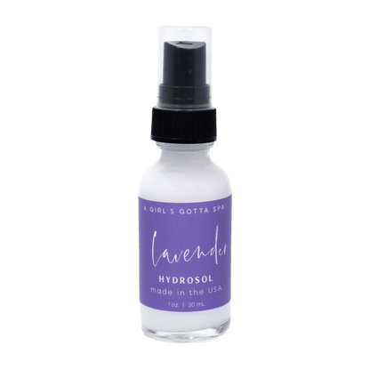 Bottle of lavender hydrosol with a purple label on a dark gray background