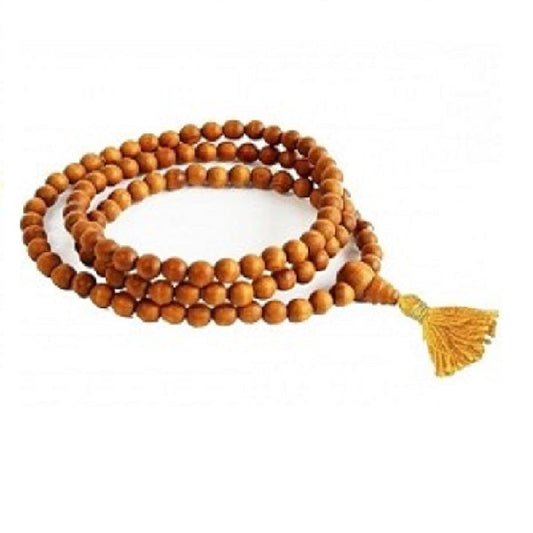 Wooden mala beads with a yellow tassel on a white background