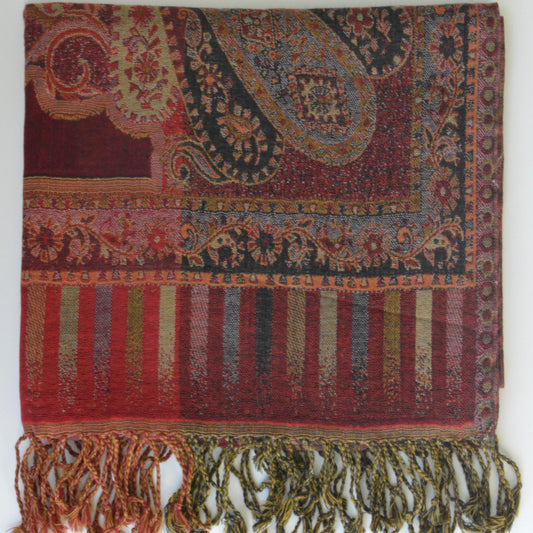 Colorful patterned fabric with fringes on a white background