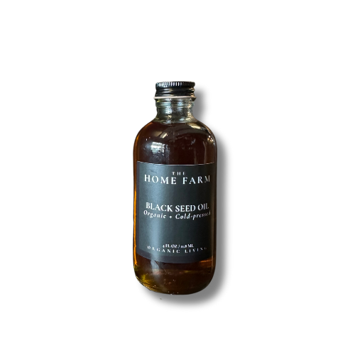 Bottle of black seed oil from The Home Farm on a white background
