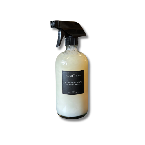 Clear spray bottle with black nozzle labeled 'The Home Farm' on a white background